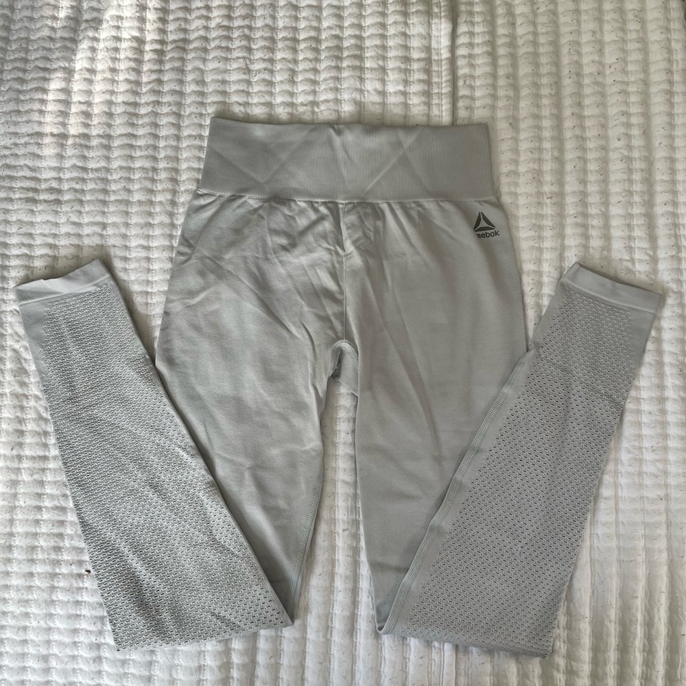 grey reebok high-waisted 7/8 leggings with laser cut details